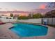 Cool blue pool with diving board, adjacent patio furniture, and a basketball hoop at 3457 E Ellis St, Mesa, AZ 85213
