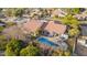 Exterior elevation featuring a covered patio, swimming pool, and lounge chairs in a lush, green backyard at 3457 E Ellis St, Mesa, AZ 85213