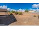Spacious backyard with gravel and a partial view of neighboring homes at 3555 S Moccasin Trl, Gilbert, AZ 85297
