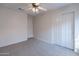 Bright bedroom with ceiling fan, double-door closet, and carpet flooring at 3555 S Moccasin Trl, Gilbert, AZ 85297
