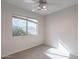 Well-lit bedroom featuring a window with blinds and carpet flooring at 3555 S Moccasin Trl, Gilbert, AZ 85297