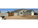 Newly built home with gray exterior and wood gate at 3720 N Del Monte Dr, Eloy, AZ 85131