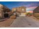 Two-story house with a white garage door and desert landscaping at 42930 W Samuel Dr, Maricopa, AZ 85138