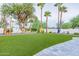 Artificial grass lawn with playhouse and pathway at 4639 E Mountain View Ct, Phoenix, AZ 85028