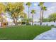 Artificial turf lawn, playhouse, and mature trees at 4639 E Mountain View Ct, Phoenix, AZ 85028