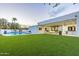 Luxury backyard oasis with a sparkling pool, artificial turf, and covered patio at 4639 E Mountain View Ct, Phoenix, AZ 85028