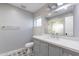 Modern bathroom with gray vanity, white subway tile, and a glass shower at 4639 E Mountain View Ct, Phoenix, AZ 85028