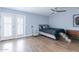 Bedroom with wood floors, ceiling fan and access to backyard at 4639 E Mountain View Ct, Phoenix, AZ 85028