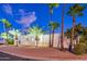 Beautiful desert home with palm trees and architectural details at night at 4639 E Mountain View Ct, Phoenix, AZ 85028