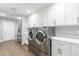 Laundry room with washer, dryer and ample storage at 4639 E Mountain View Ct, Phoenix, AZ 85028