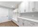 Laundry room with white cabinets and built-in bench at 4639 E Mountain View Ct, Phoenix, AZ 85028