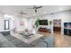 Spacious living room with hardwood floors, large TV, and access to backyard at 4639 E Mountain View Ct, Phoenix, AZ 85028