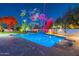 Expansive pool and spa with dramatic lighting and lush landscaping at 4639 E Mountain View Ct, Phoenix, AZ 85028