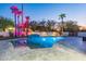 Modern pool and spa with dramatic lighting and a large patio at 4639 E Mountain View Ct, Phoenix, AZ 85028