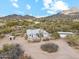 Aerial view of a ranch style house with desert landscaping and mountain views at 5428 E El Sendero Dr, Cave Creek, AZ 85331