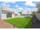Spacious backyard with a pool, lush lawn, and modern landscaping at 5825 E Cochise Rd, Paradise Valley, AZ 85253