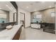 Luxurious bathroom with soaking tub, walk-in shower, and modern vanity at 5825 E Cochise Rd, Paradise Valley, AZ 85253