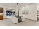 Modern dining room with pool view, adjacent to kitchen at 5825 E Cochise Rd, Paradise Valley, AZ 85253