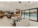 Elegant dining area with a sleek table and chairs, overlooking the pool at 5825 E Cochise Rd, Paradise Valley, AZ 85253
