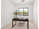 Home office with a large window overlooking the pool and backyard at 5825 E Cochise Rd, Paradise Valley, AZ 85253