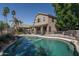 Backyard view of the pool and home exterior with manicured landscaping and fencing at 5951 W Irma Ln, Glendale, AZ 85308
