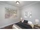 Bedroom featuring a large window overlooking outside greenery, and artwork hung on the walls at 5951 W Irma Ln, Glendale, AZ 85308