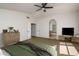 Spacious bedroom with carpet floors, ceiling fan, and an open view to the ensuite bathroom at 5951 W Irma Ln, Glendale, AZ 85308