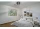 Bedroom featuring a bed, window overlooking outside greenery, framed artwork and neutral walls at 5951 W Irma Ln, Glendale, AZ 85308