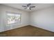Bedroom featuring a large window with neutral blinds, neutral colored carpet and neutral colored walls at 5951 W Irma Ln, Glendale, AZ 85308