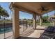 Covered patio with a view of the backyard pool and lush greenery, ideal for outdoor relaxation at 5951 W Irma Ln, Glendale, AZ 85308