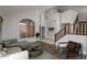 Welcoming foyer with high ceilings, wood floors, staircase, and large arched window at 5951 W Irma Ln, Glendale, AZ 85308