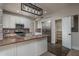 Modern kitchen with granite countertops, stainless steel appliances, and an island for ample prep space at 5951 W Irma Ln, Glendale, AZ 85308
