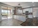 Modern kitchen featuring white cabinets, granite countertops, stainless steel appliances, and a breakfast bar at 5951 W Irma Ln, Glendale, AZ 85308