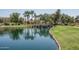 Peaceful lake with a waterfall feature and walking paths, enhancing the community's natural beauty at 5951 W Irma Ln, Glendale, AZ 85308
