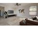 Spacious living room with a ceiling fan, neutral decor, and plenty of natural light at 5951 W Irma Ln, Glendale, AZ 85308