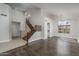 Open-concept living room with staircase and modern design elements providing abundant natural light at 5951 W Irma Ln, Glendale, AZ 85308