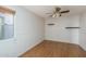Bright room with wood floors, a window, chair rail, and a ceiling fan, ready for customization at 5951 W Irma Ln, Glendale, AZ 85308