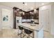 Modern kitchen with dark cabinetry, stainless steel appliances, and a kitchen island at 6565 E Thomas Rd # 1005, Scottsdale, AZ 85251