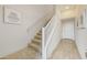 Modern staircase with a light-toned wood railing and carpeted steps at 6565 E Thomas Rd # 1005, Scottsdale, AZ 85251