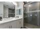 Modern bathroom with double sinks and a stylish glass-enclosed shower at 6990 E 6Th St # 1005, Scottsdale, AZ 85251