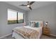 This bedroom features a large window and ceiling fan at 6990 E 6Th St # 1005, Scottsdale, AZ 85251