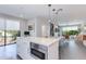 Open-concept kitchen features a spacious island with seating and modern microwave at 6990 E 6Th St # 1005, Scottsdale, AZ 85251