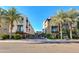 Street view of multiple level condominium units and palm trees at 6990 E 6Th St # 1005, Scottsdale, AZ 85251