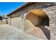 Front view of the house with stone archway entry and garage at 7010 W Medlock Dr, Glendale, AZ 85303