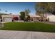 Single story home with artificial turf lawn, two-car garage, and mature landscaping at 7956 E Via Costa --, Scottsdale, AZ 85258