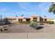 Tan stucco house with a red tile roof, two car garage, and nicely landscaped front yard at 8412 N Via Mia --, Scottsdale, AZ 85258