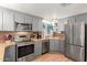 Updated kitchen features stainless steel appliances and gray cabinets at 9333 E University Dr # 55, Mesa, AZ 85207