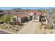 Single-level home with tile roof, driveway, and desert landscaping; mountain views at 9514 E Cavalry Dr, Scottsdale, AZ 85262
