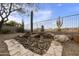 Backyard with a stone pathway, fountain and desert landscape at 9514 E Cavalry Dr, Scottsdale, AZ 85262