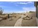 Landscaped backyard with stone pathway, and desert plants at 9514 E Cavalry Dr, Scottsdale, AZ 85262